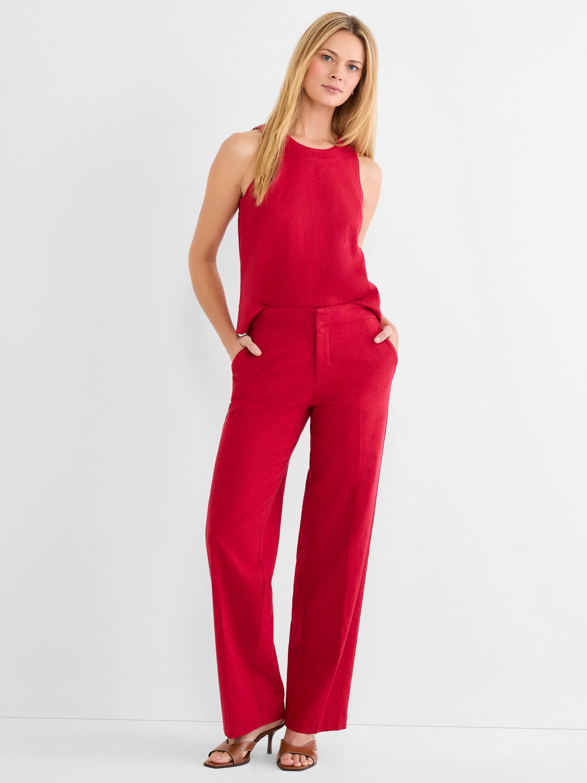Red wide leg stretch linen pants on a model, showing a flat front and side pockets.