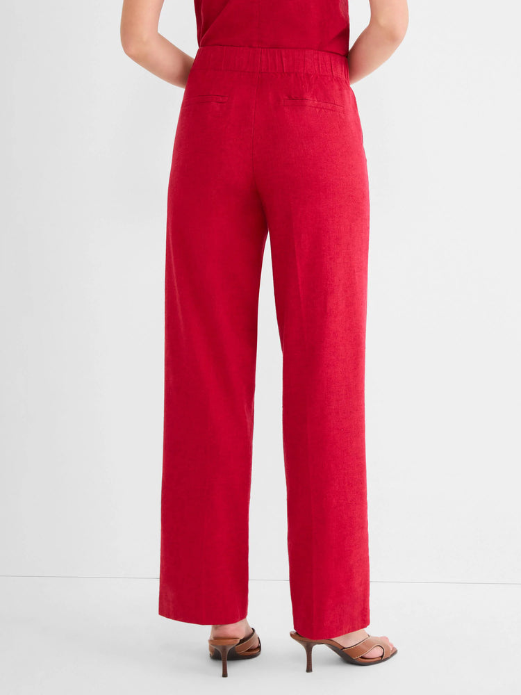 Red wide-leg linen pants on a model, shown from behind. Features an elasticated waist and two back pockets.