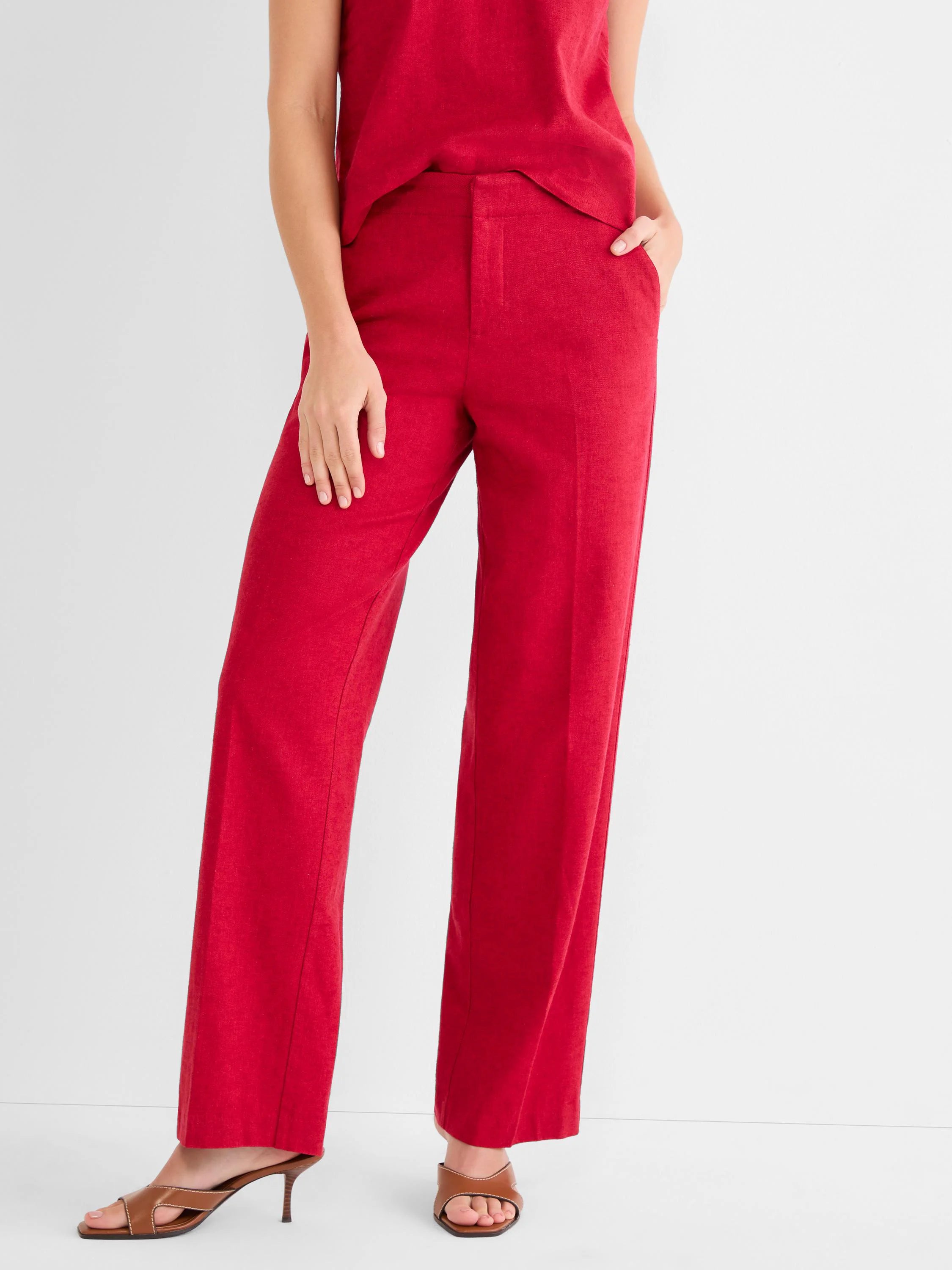 Red wide-leg linen pants with a high waist and textured fabric. Smooth front closure.