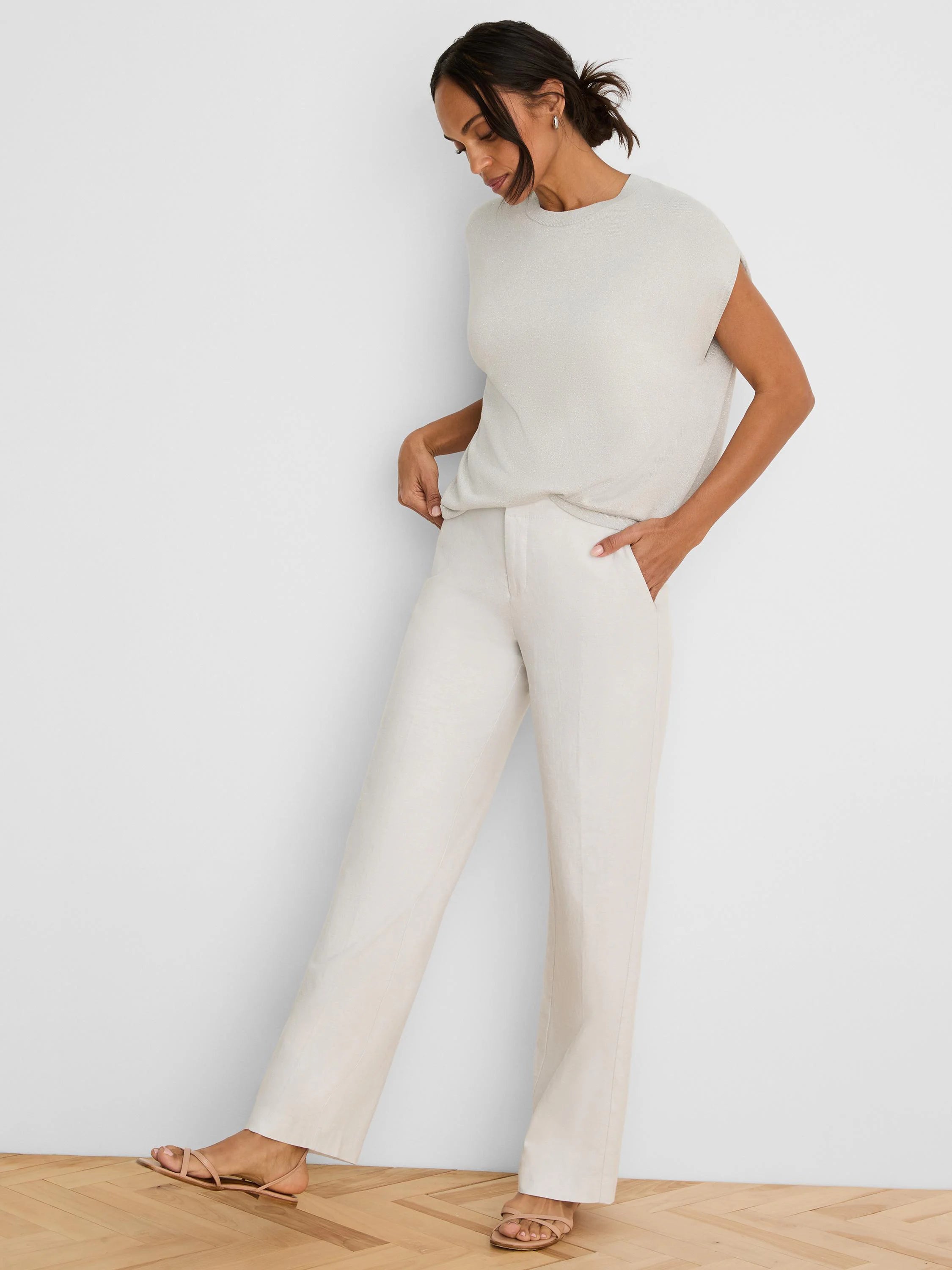 Off-white wide-leg linen pants with front pockets, shown on a model.