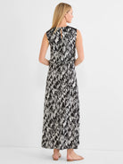 Black and white cursive print maxi dress, sleeveless, with a cinched waist and keyhole back.