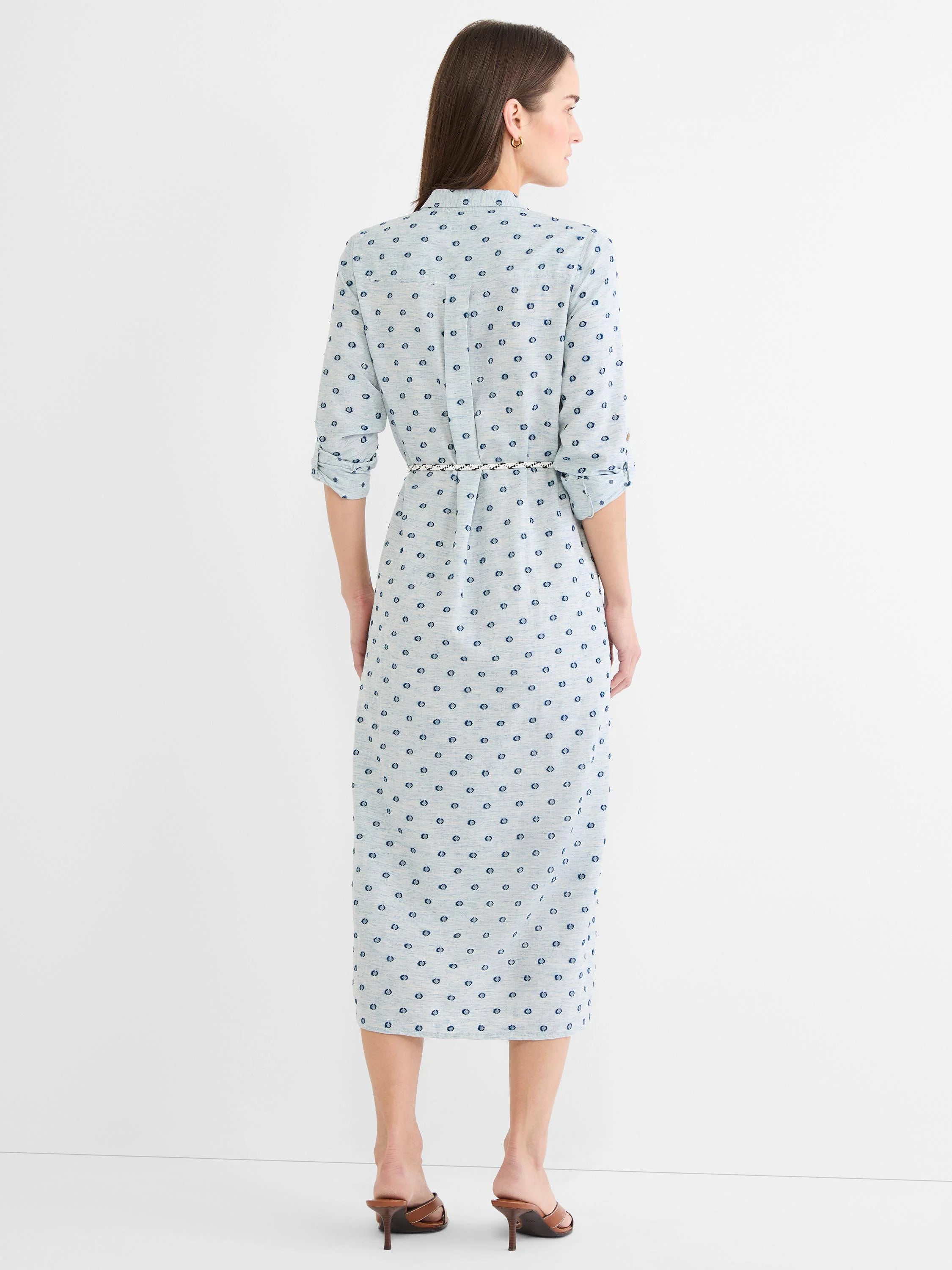 Light blue midi shirt dress with dark blue clipped dots, cuffed sleeves, and a white rope belt.