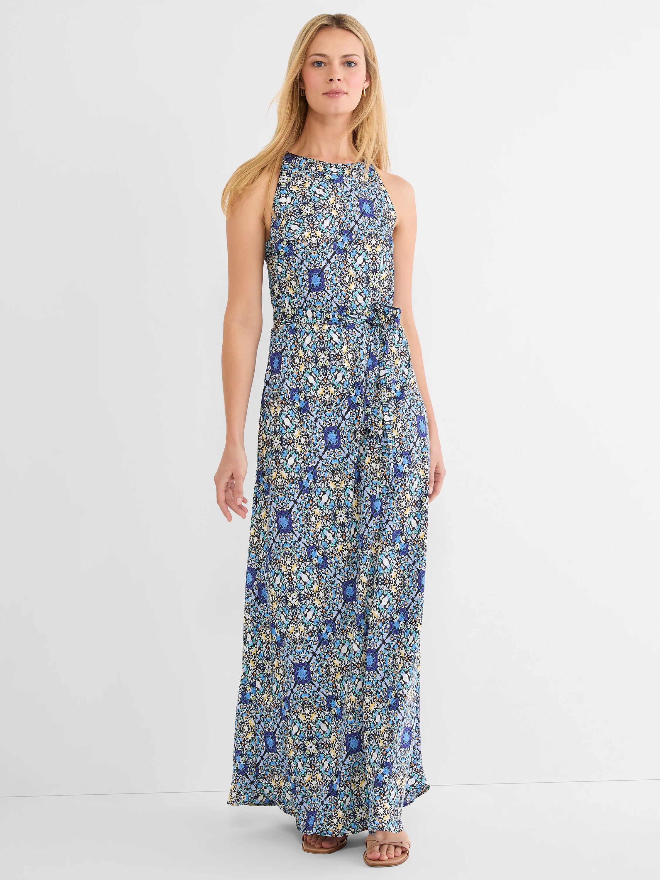 Maxi dress with high neck, sleeveless, and self-tie belt. Features an intricate blue, yellow, and black tile pattern.