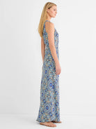 Sleeveless maxi dress with intricate blue, yellow, and teal tile pattern on a dark background.