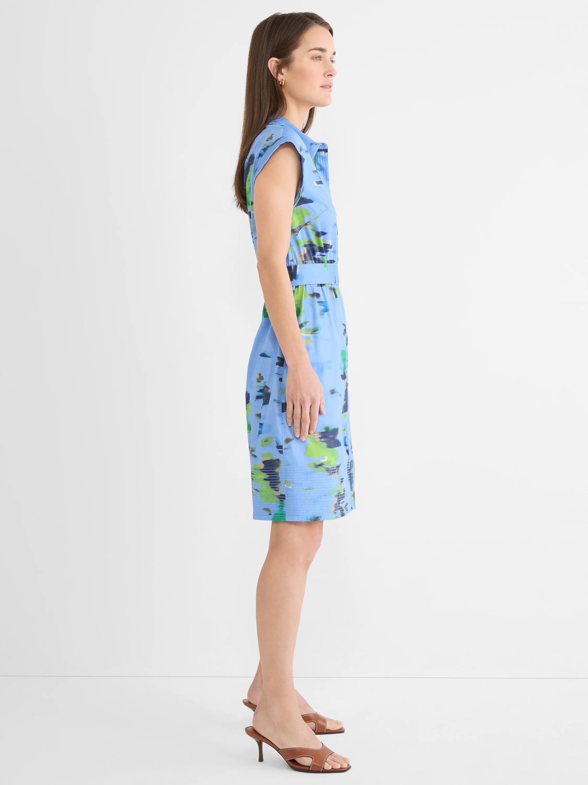 Sleeveless light blue dress with abstract green and navy water lily print, collared, with a belted waist and knee-length...