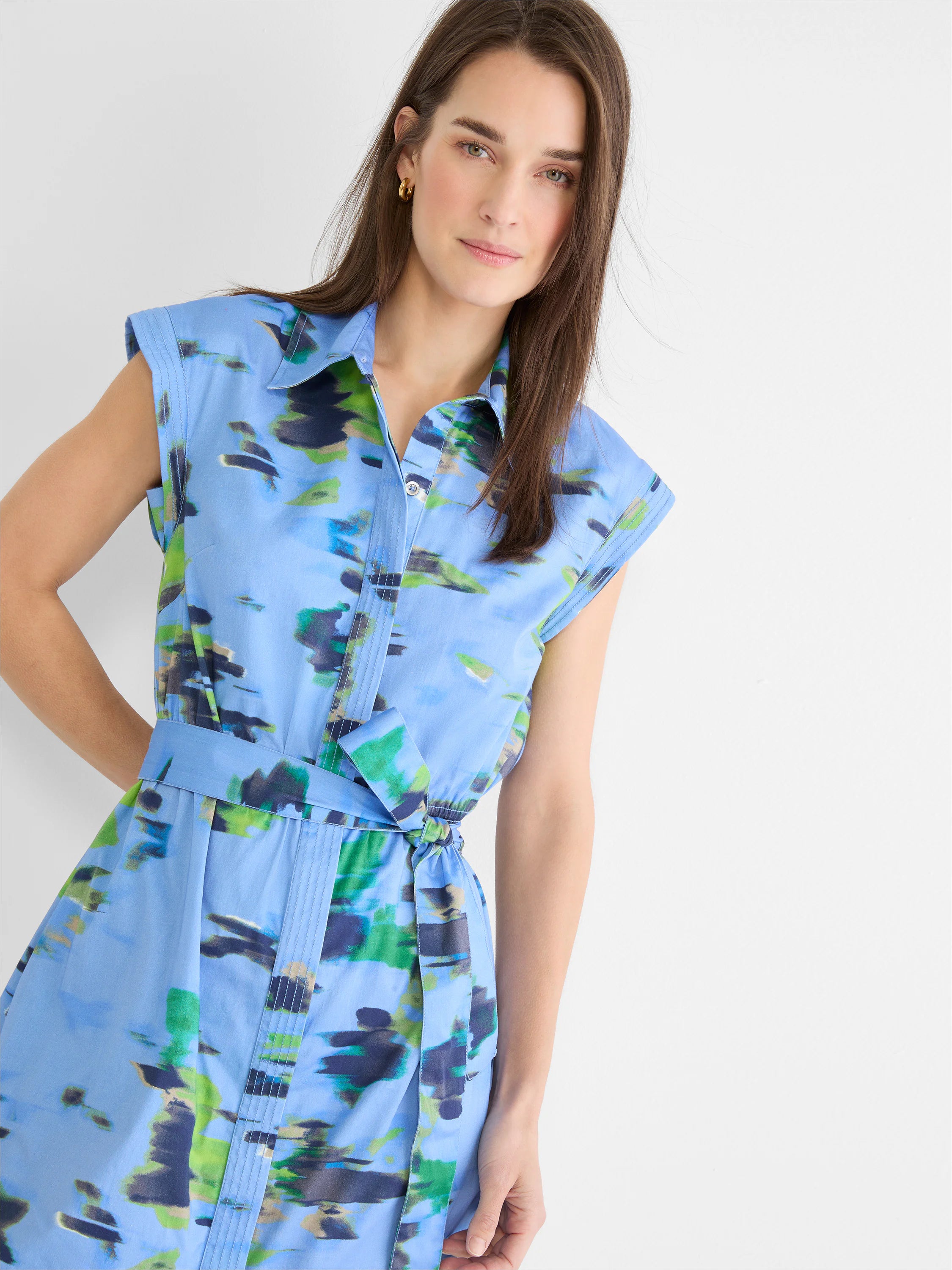 Blue sleeveless shirtdress with green & navy water lily print, featuring a collar and belted waist.