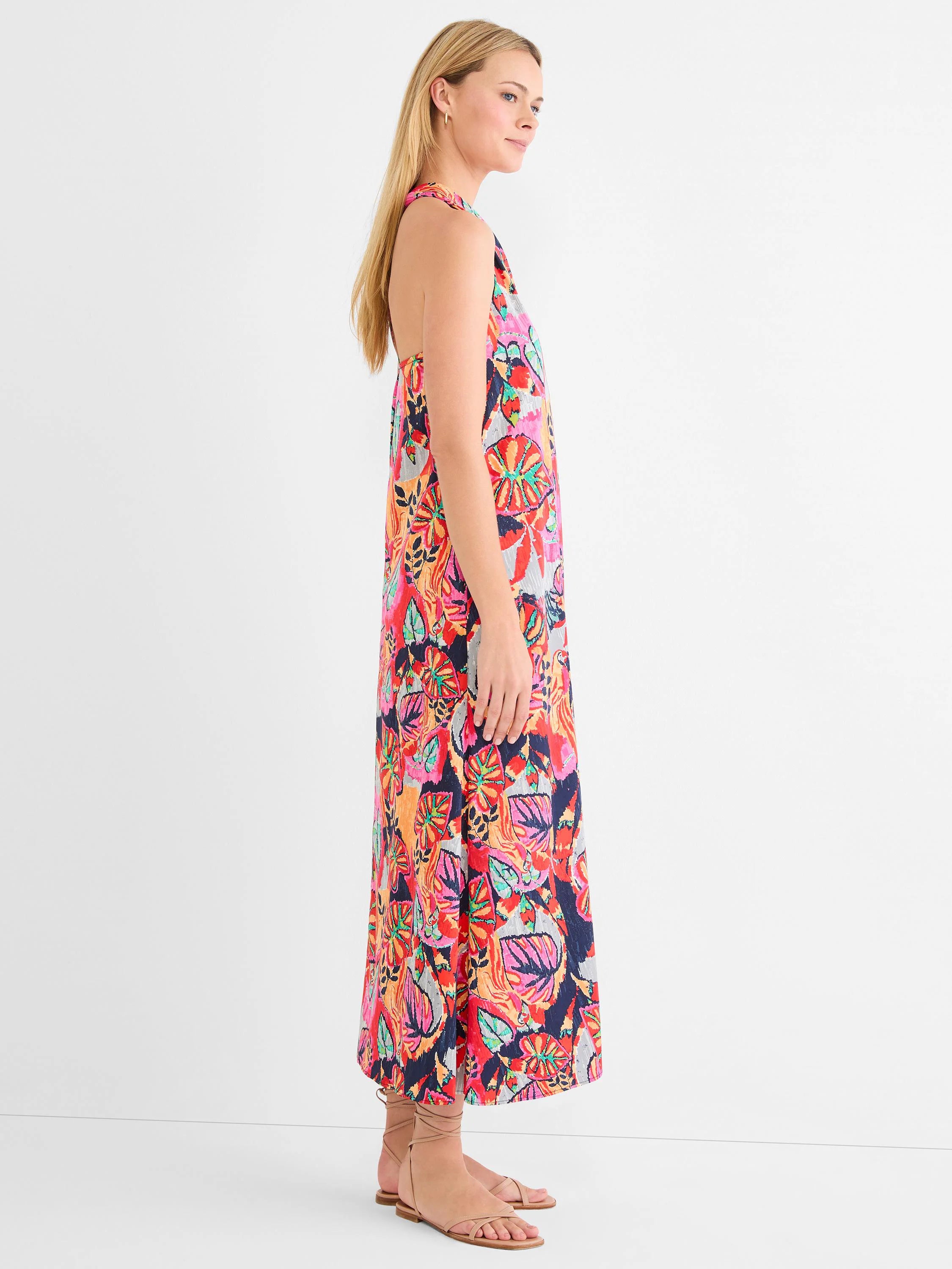 Sleeveless maxi dress with vibrant tropical print in fuchsia, orange, red, navy, and teal colors.