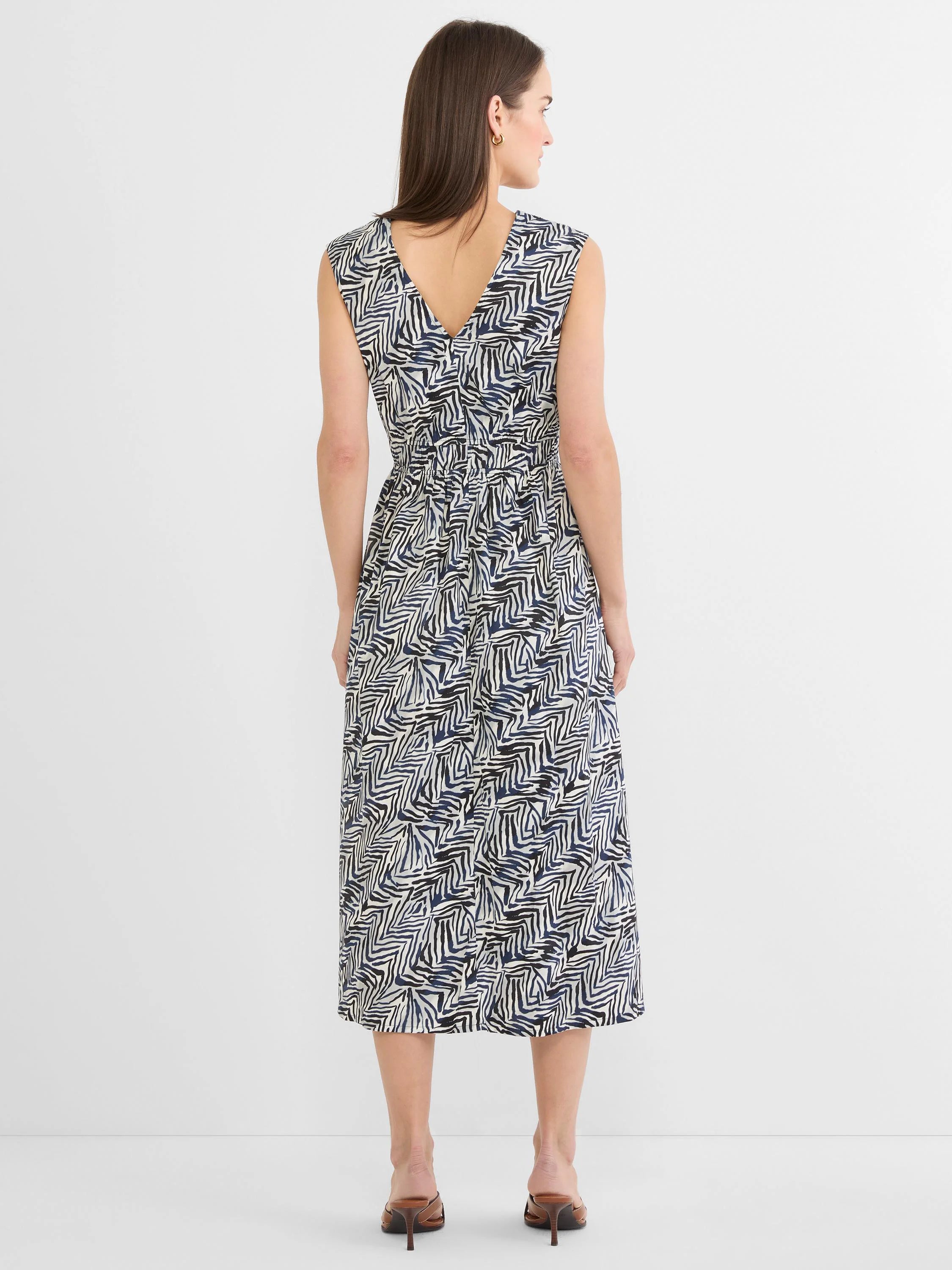 Sleeveless midi dress, V-back, elasticated waist. Features an off-white base with dark blue and black inked lines pattern.