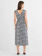 Sleeveless midi dress, V-back, elasticated waist. Features an off-white base with dark blue and black inked lines pattern.