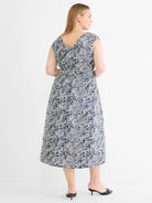 Midi dress with an abstract pattern of navy blue & black angular lines on off-white. V-neck back, cap sleeves, cinched waist.