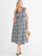 Dierdre Dress: Sleeveless V-neck midi with an elasticated waist and an abstract black, navy, and off-white line pattern.