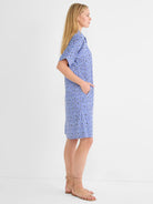 Blue, white, and dark geometric mosaic print shirt dress. Knee-length, short sleeves, with pockets.