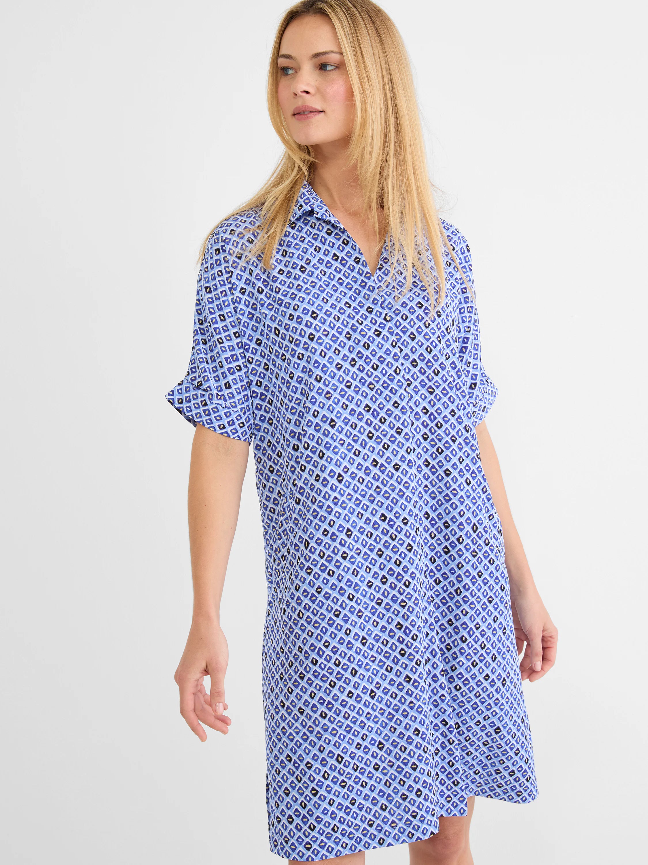 Blue mosaic dress with geometric pattern of light/dark blue, black, and tan shapes. Features a collar, V-neck, cuffed...