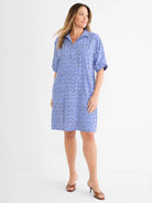 Blue and black mosaic pattern dress, collared V-neck, cuffed short sleeves, knee-length.