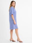 Blue collared dress with geometric square pattern in blue and black. Short sleeves, knee-length.