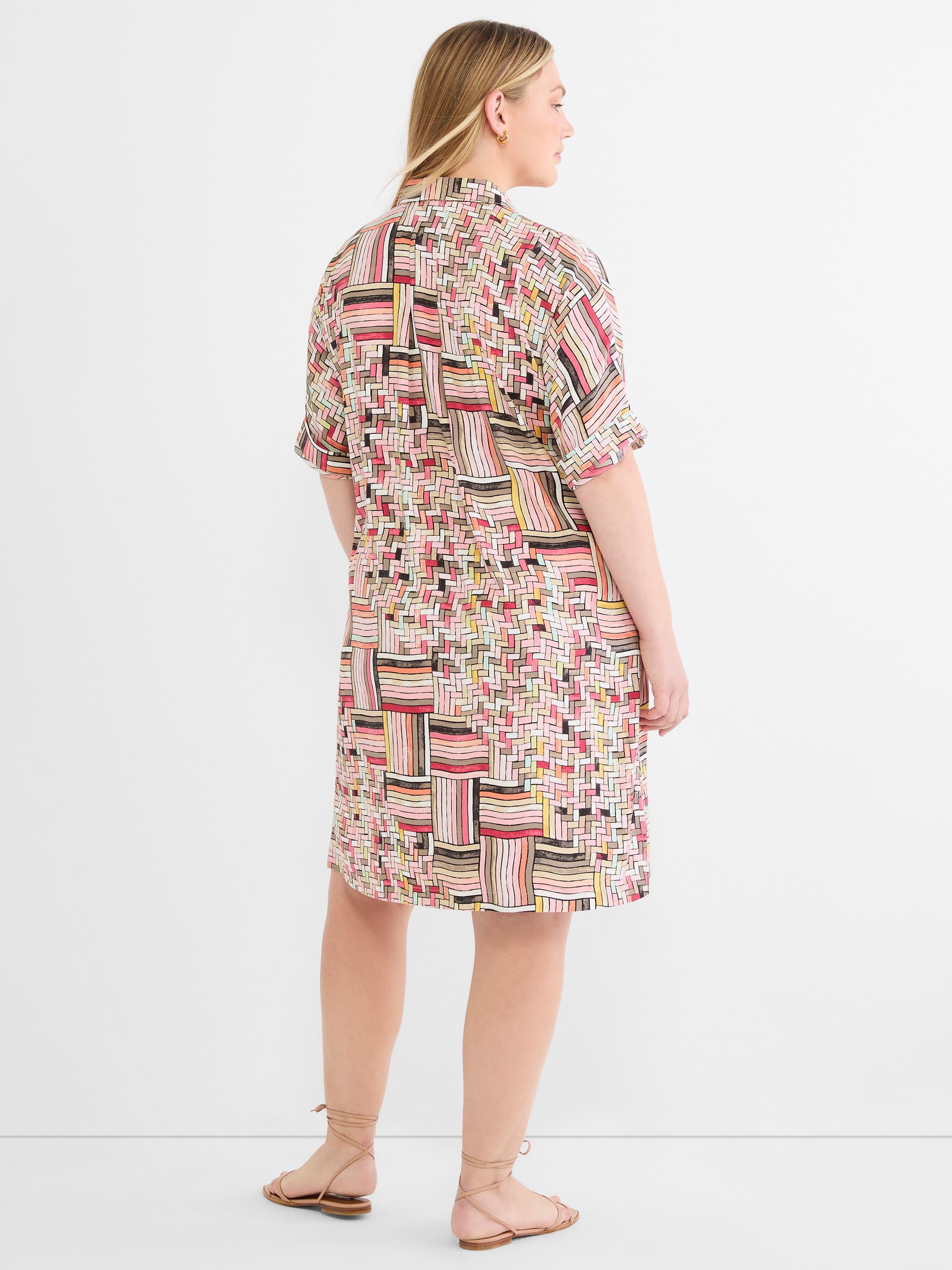 Pink and multicolor geometric print shirt dress fits relaxed with short sleeves and a cinched back waist.