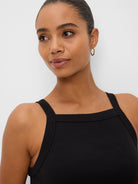 Black ribbed square neck tank with wide straps, worn by a model.