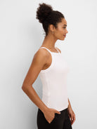 Off-white ribbed square neck tank top, shown fitted on a model.