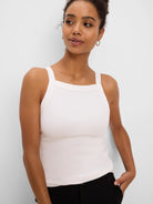 Ivory ribbed tank top with a square neck and wide straps.