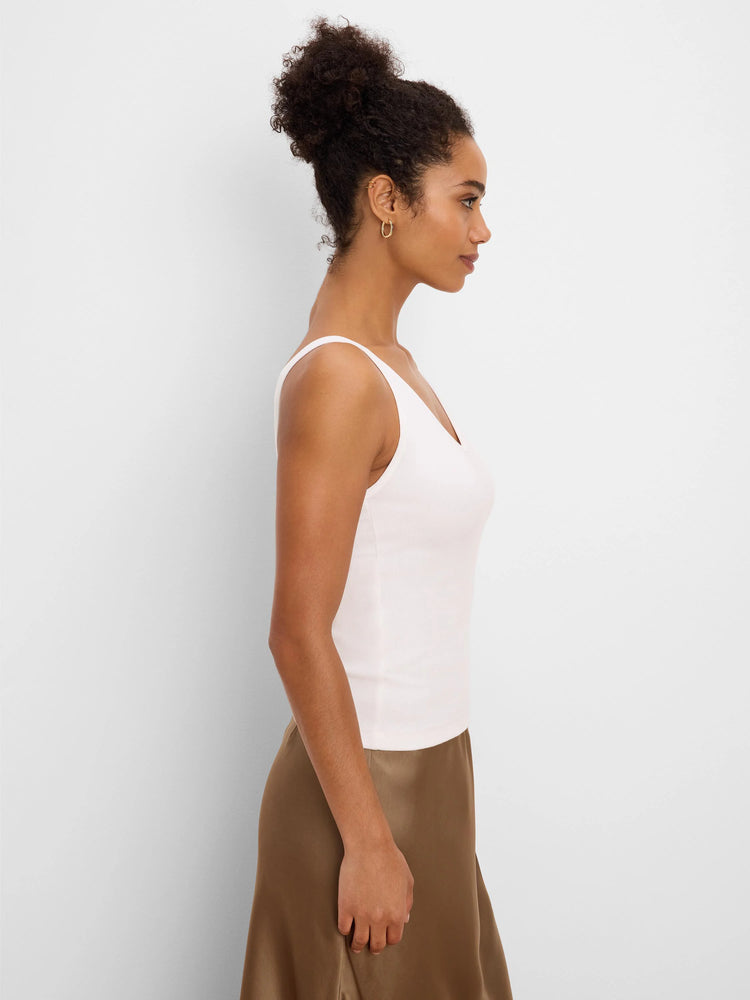 Fitted pale pink ribbed V-neck tank top.