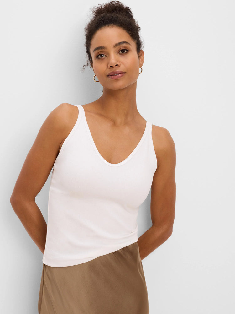 Light cream ribbed V-neck tank top on a model.