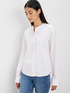 White cotton collarless shirt with a band collar, front buttons, and long sleeves with wide cuffs.