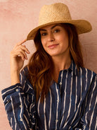 Natural woven straw rancher hat with a wide, structured brim and a creased crown.