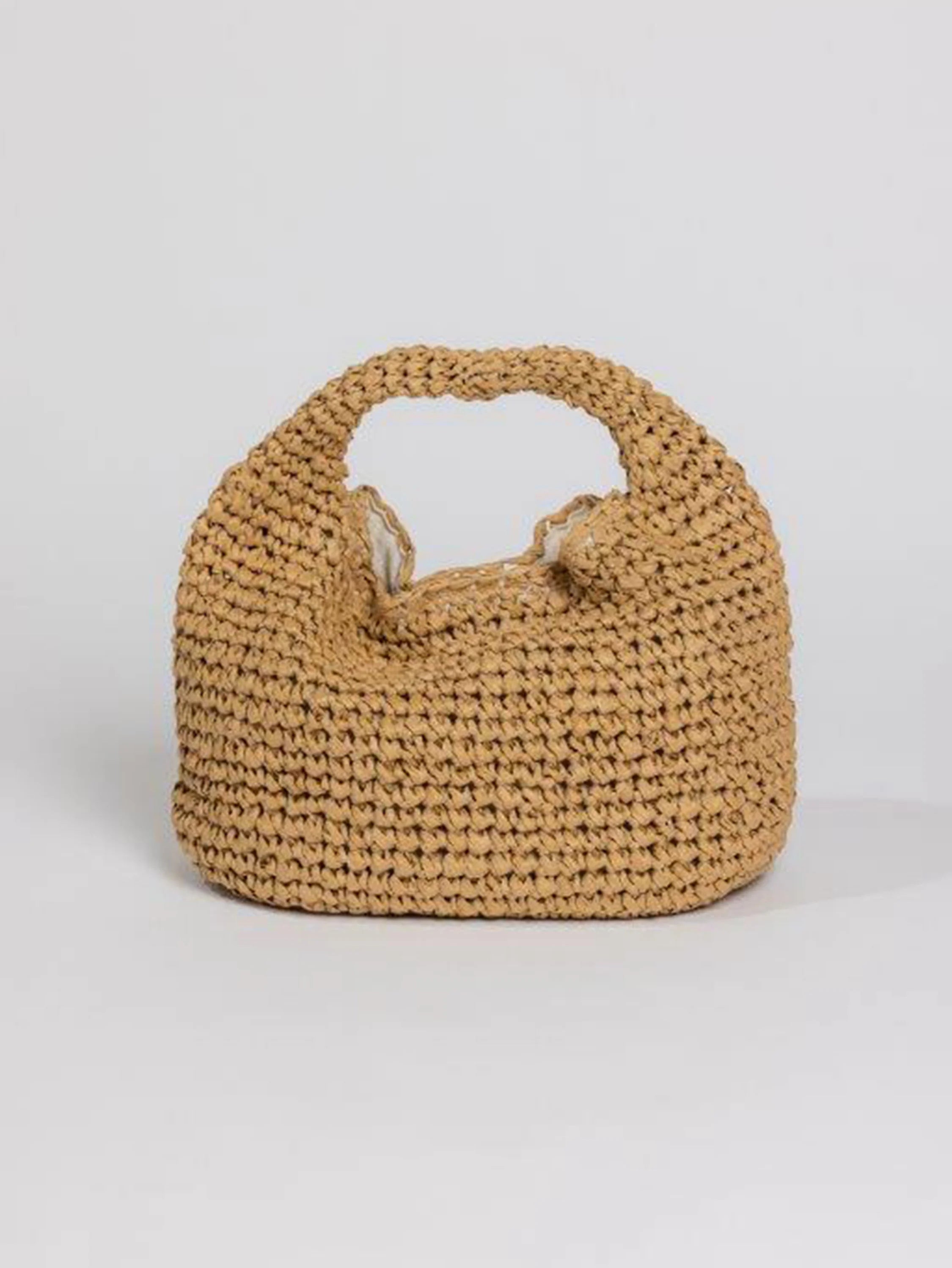 Tan crocheted slouch bag with a rounded, unstructured shape, wide integrated handle, and light lining.