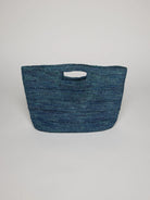 Teal blue crocheted handbag with a cutout handle.