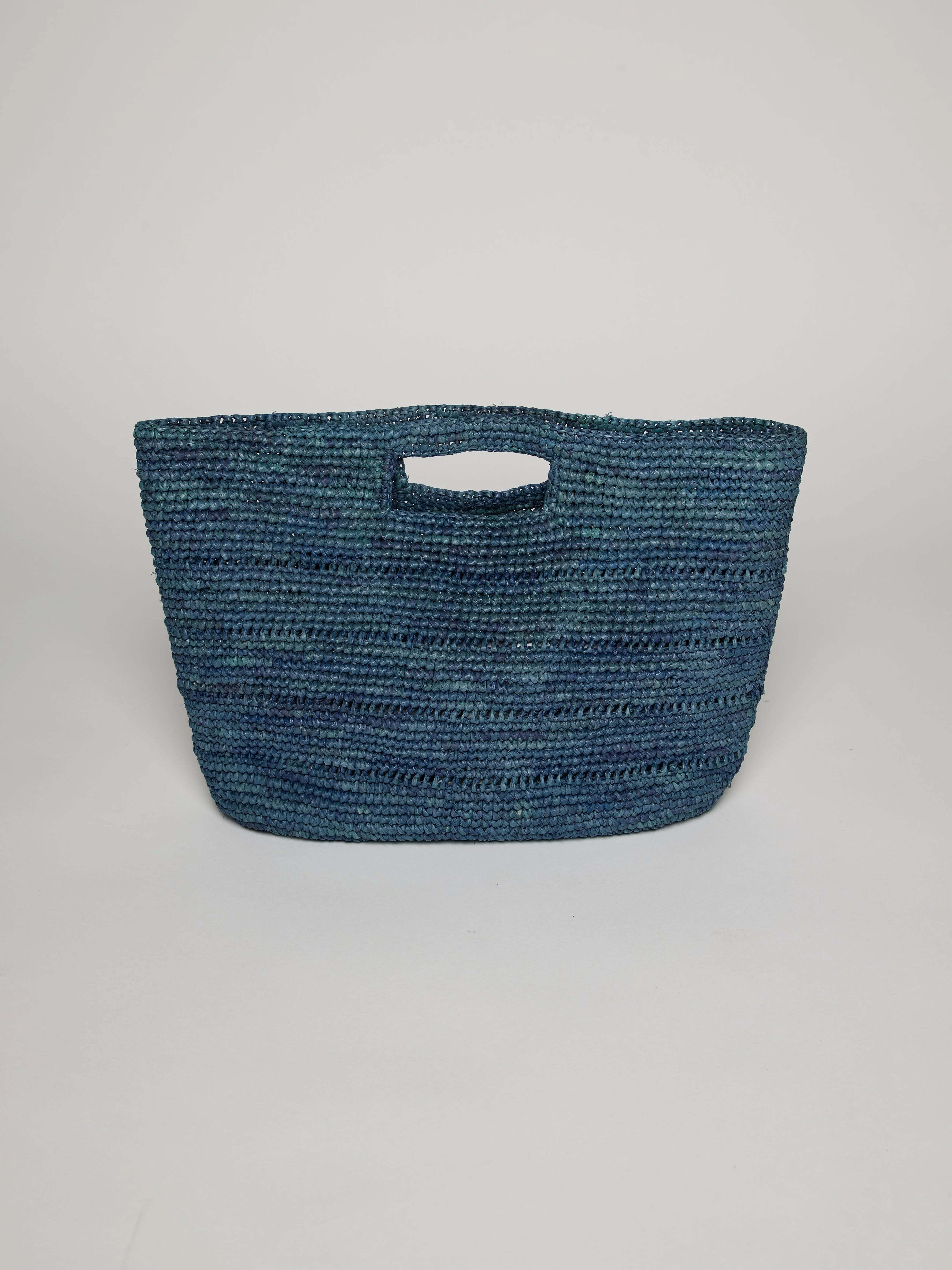 Teal blue crocheted handbag with a cutout handle.