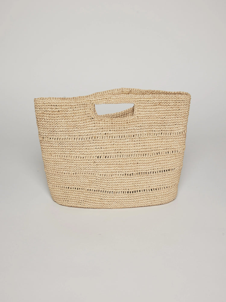 Beige woven handbag with a cutout top handle.  The bag is textured and slightly rectangular.