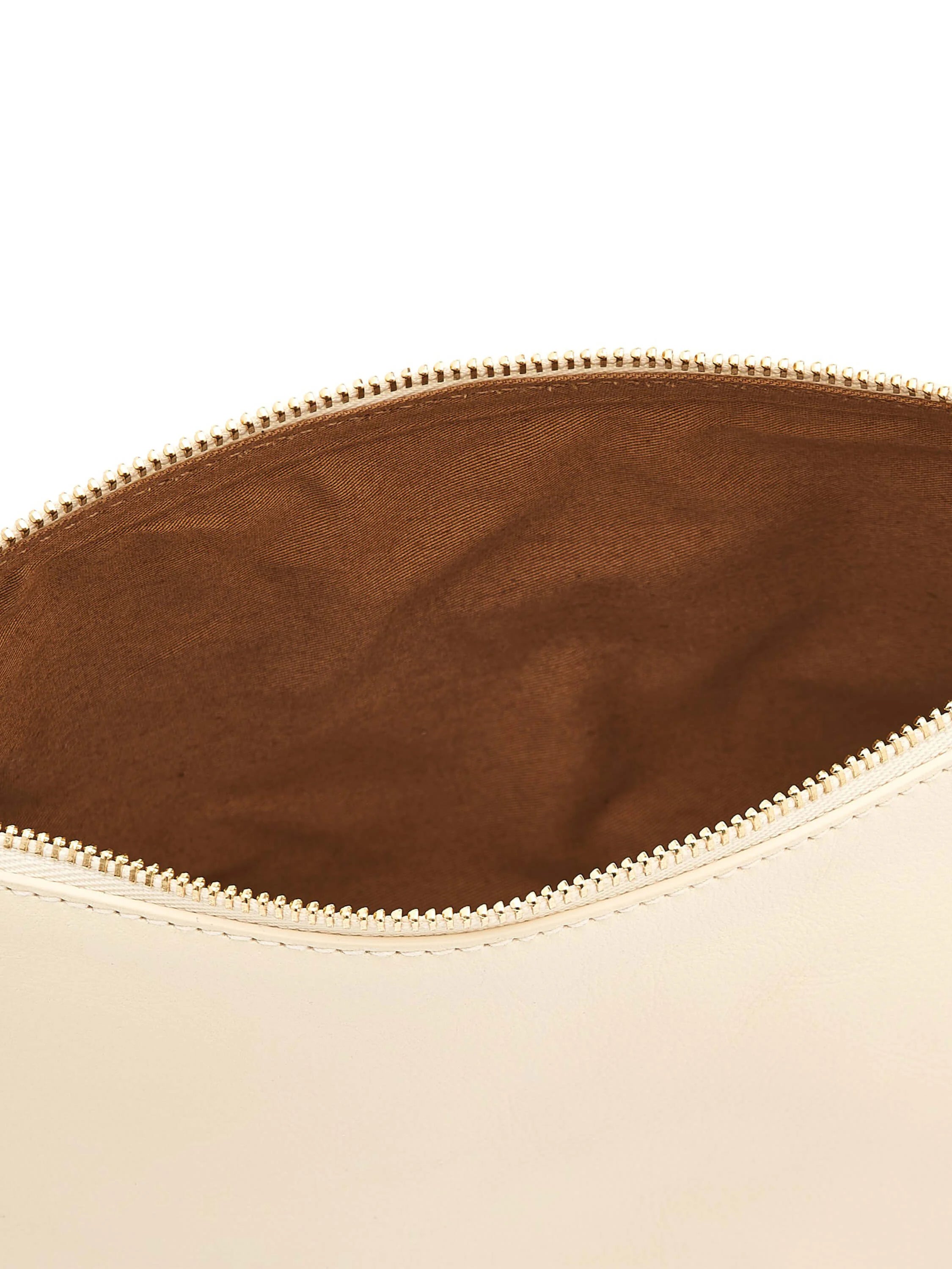 Cream leather case, open gold-toned zipper showing brown fabric lining.