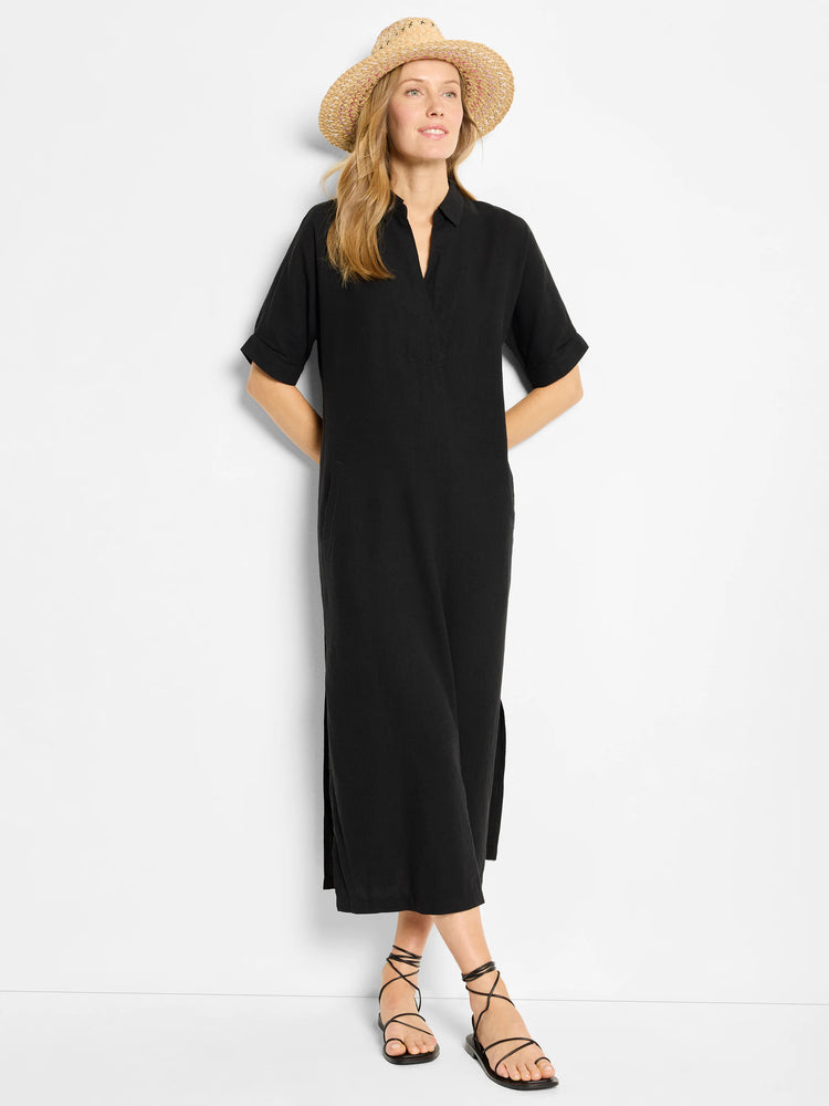 Beige straw hat with pink/white accents, worn by model in black, knee-length, short-sleeved dress with side slits.  Model...