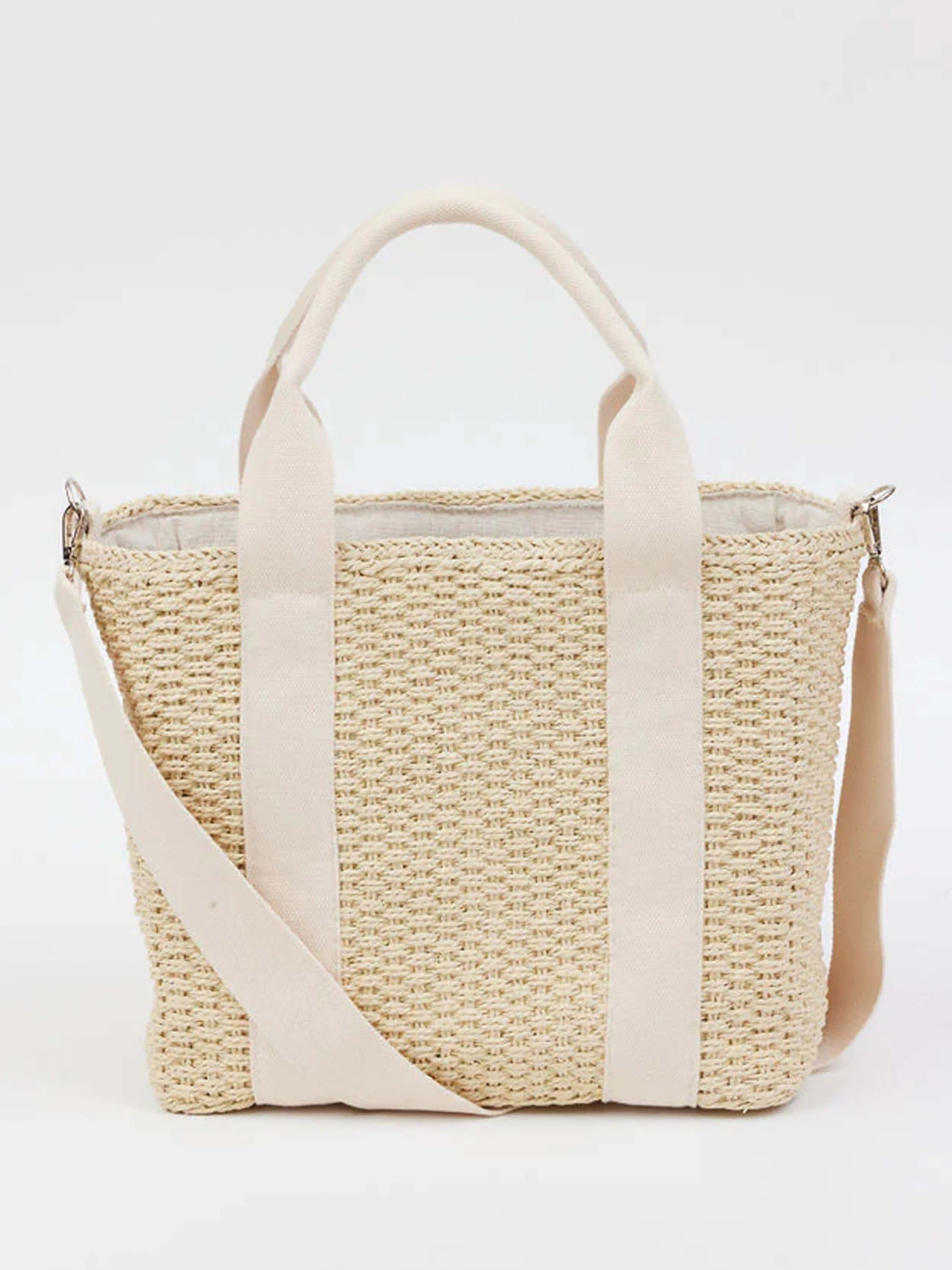 Off-white woven straw tote bag with cream-colored canvas straps and shoulder strap.