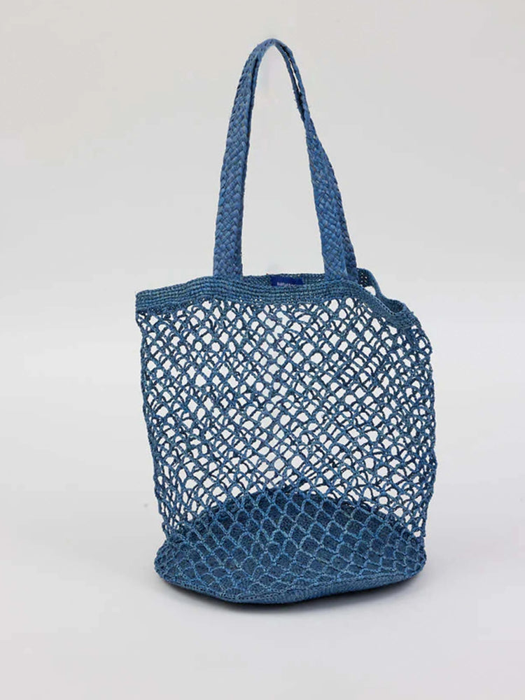Indigo blue woven tote bag with a net-like mesh body, braided handles, and solid base.