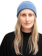 Here's alt text for the image, under 125 characters:

"Blue ribbed cashmere beanie.  Woman with blonde hair models it...