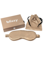 Champagne silk sleep mask, matching drawstring pouch with black ties, and rectangular box.