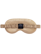 Beige silk sleep mask with elastic band.  Features a small black label.