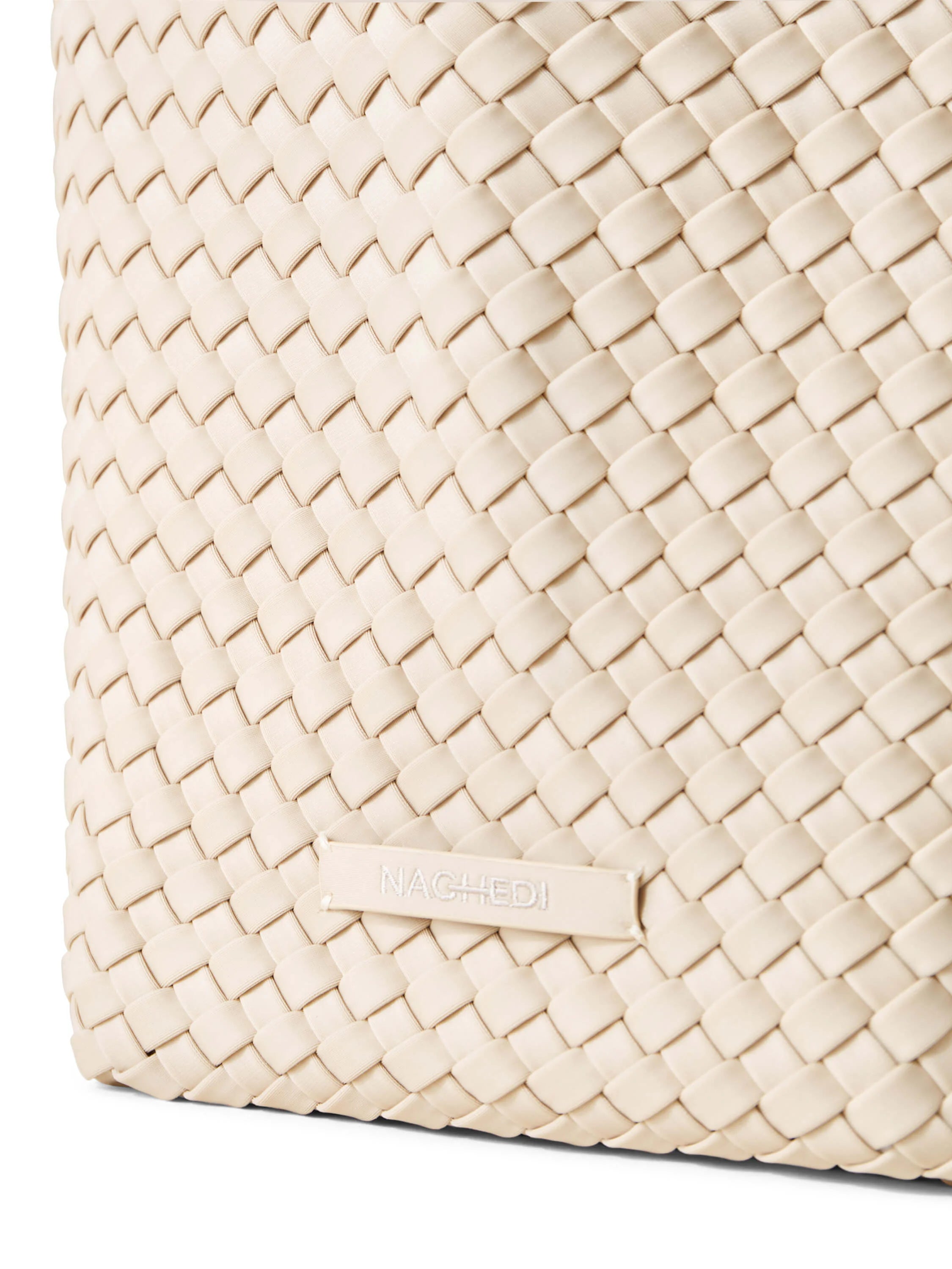 Off-white woven tote bag.  Close-up shows a tightly woven, textured pattern.  Brand label visible.