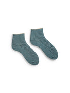 Ribbed, muted teal shortie socks with light beige cuffs.