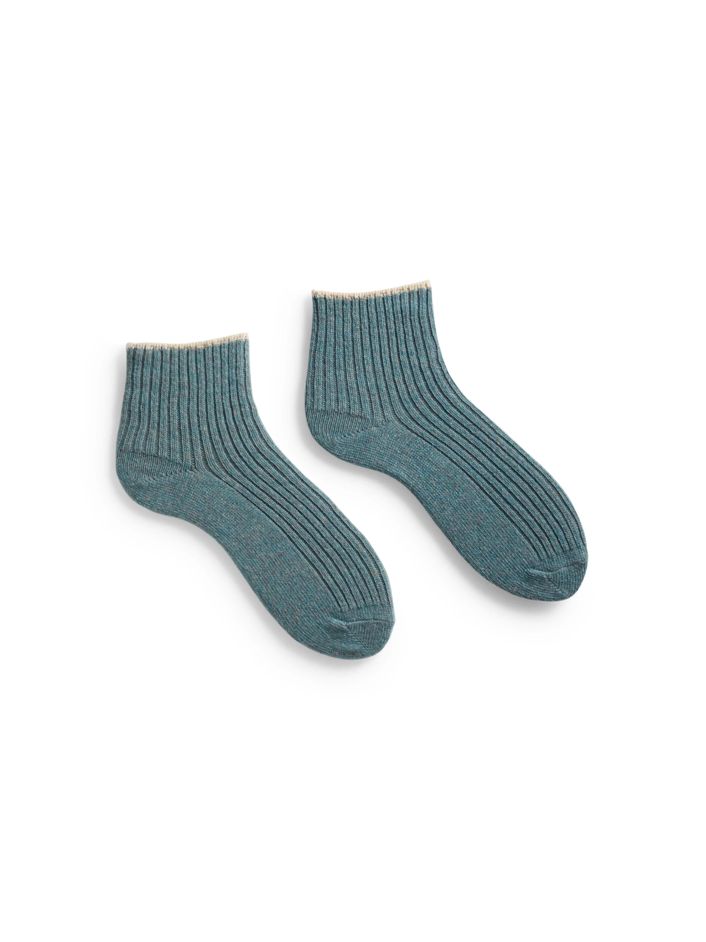 Pair of teal ribbed shortie socks with a beige cuff.