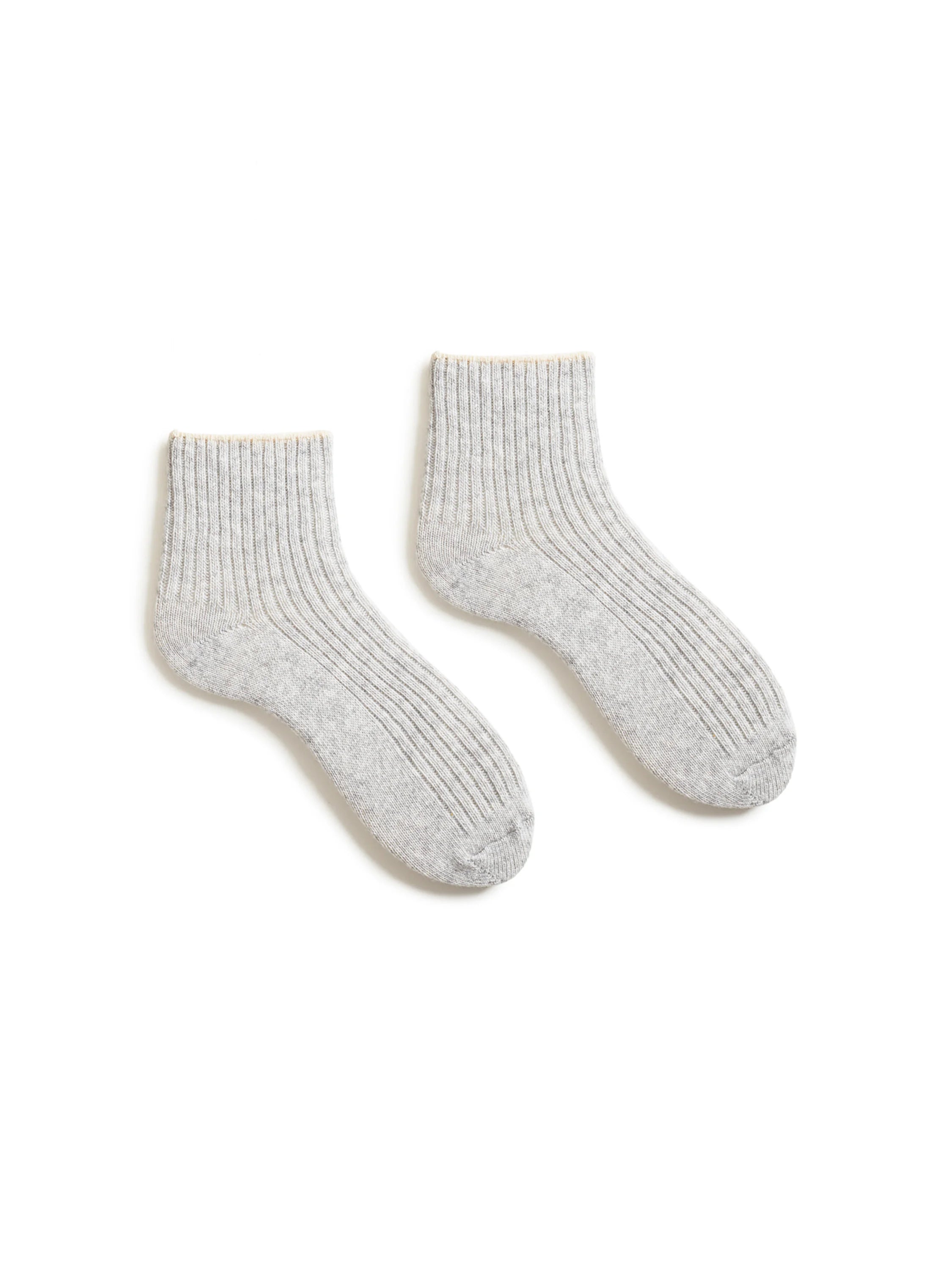 Pair of gray ribbed ankle socks with a pale yellow top trim.