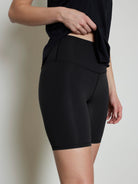 Varley Let's Move Short: Black, high-waisted, mid-thigh length. Features visible flatlock seams.