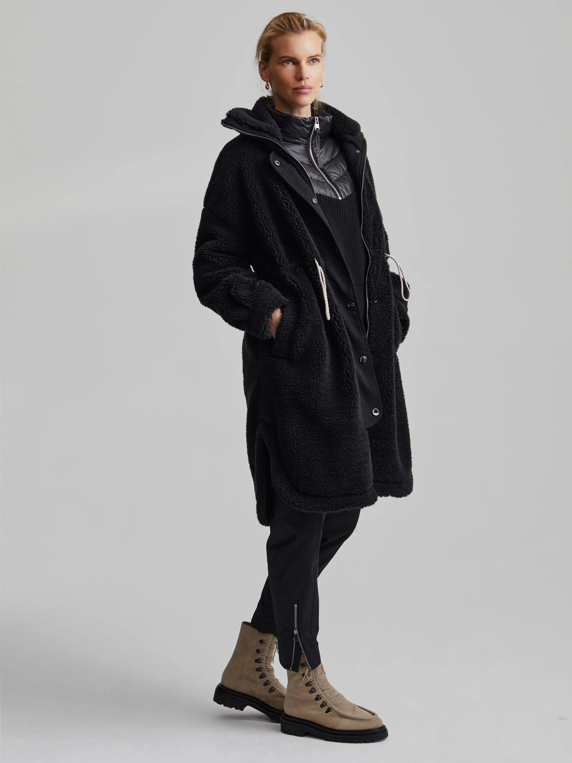 Black Varley Jones Coat: Textured fleece, mid-length, with an inner puffer layer and white drawstring.
