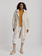 Off-white long sherpa-style coat with gold zippers.  Features drawstring waist.