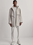 Light beige raincoat; long sleeves, zip front, and hood.