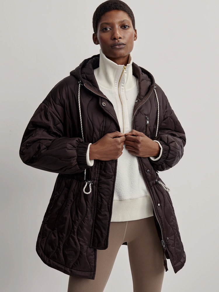 Dark brown quilted jacket with a hood and zipper.  Features drawstring waist and off-white drawcords.