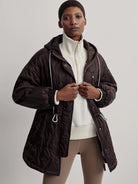 Dark brown hooded quilted jacket features wavy stitching, white drawstrings, and front zipper closure.
