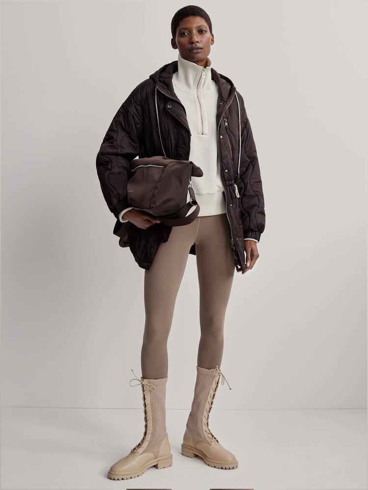 Dark brown, hooded, wavy-quilted jacket with white drawstrings and a relaxed fit.