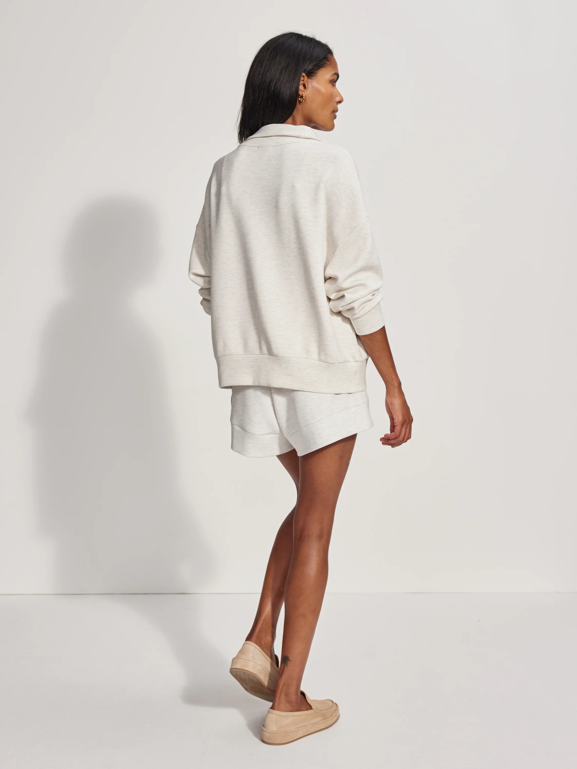 Relaxed, heathered oatmeal half-zip sweater with a collar, long sleeves, and ribbed cuffs/hem.